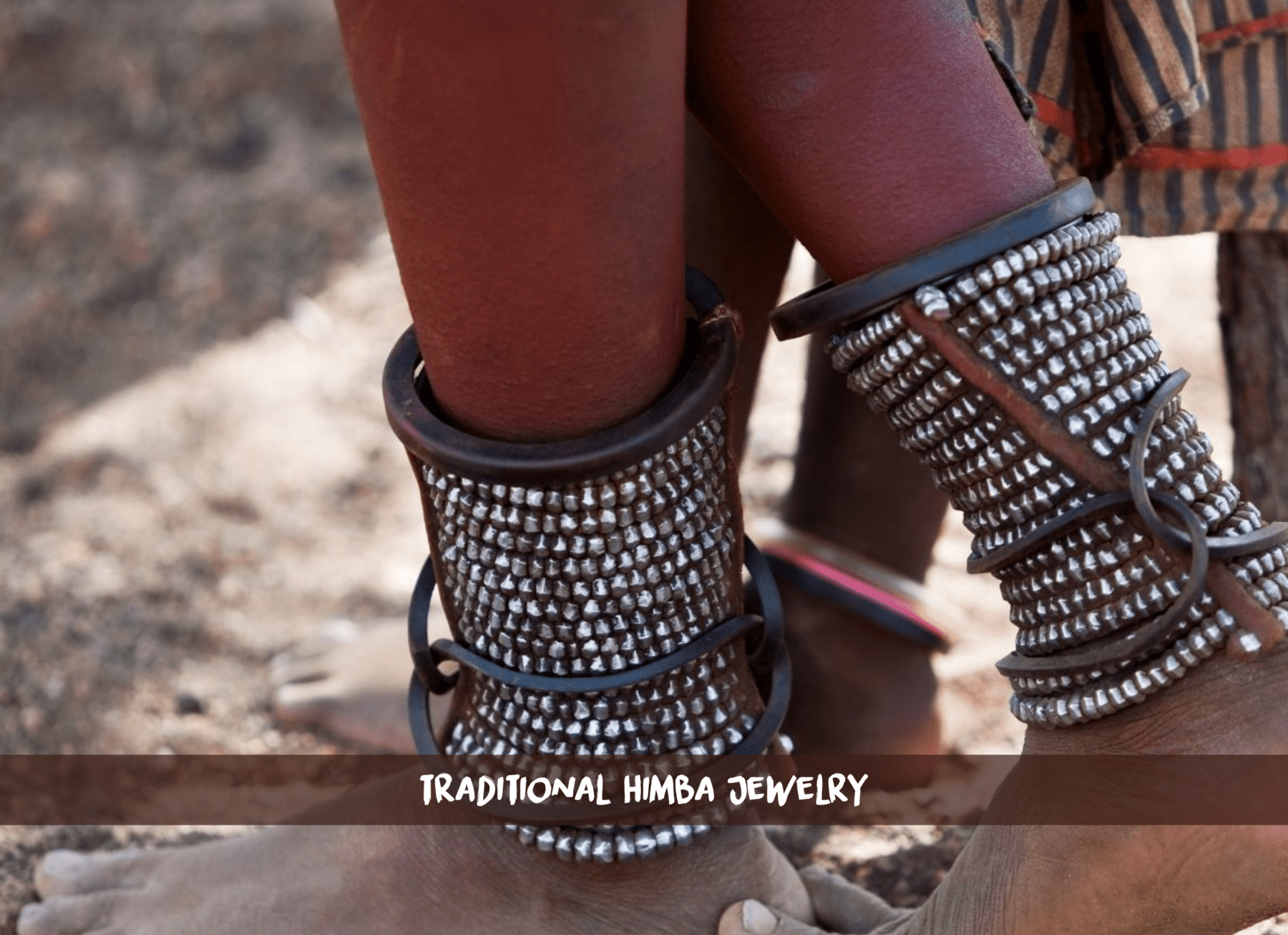 Ein Paar Füße der Himba mit langem Schmuck