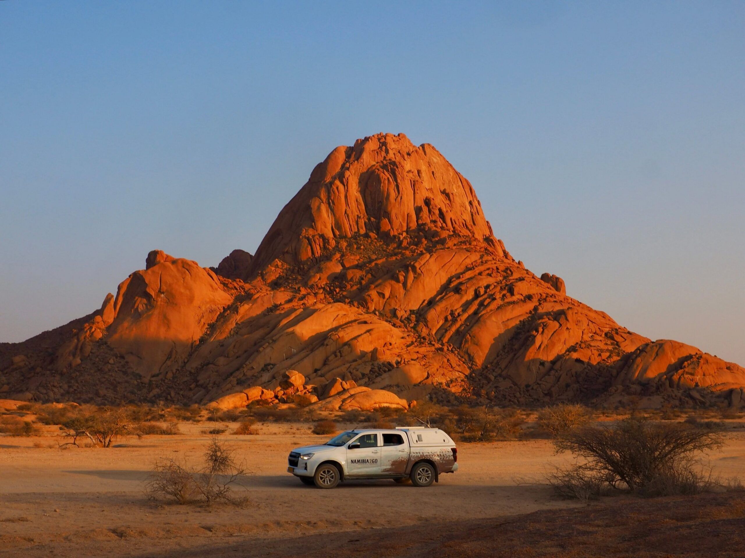 Safari vehicle parked below Spitzkoppe